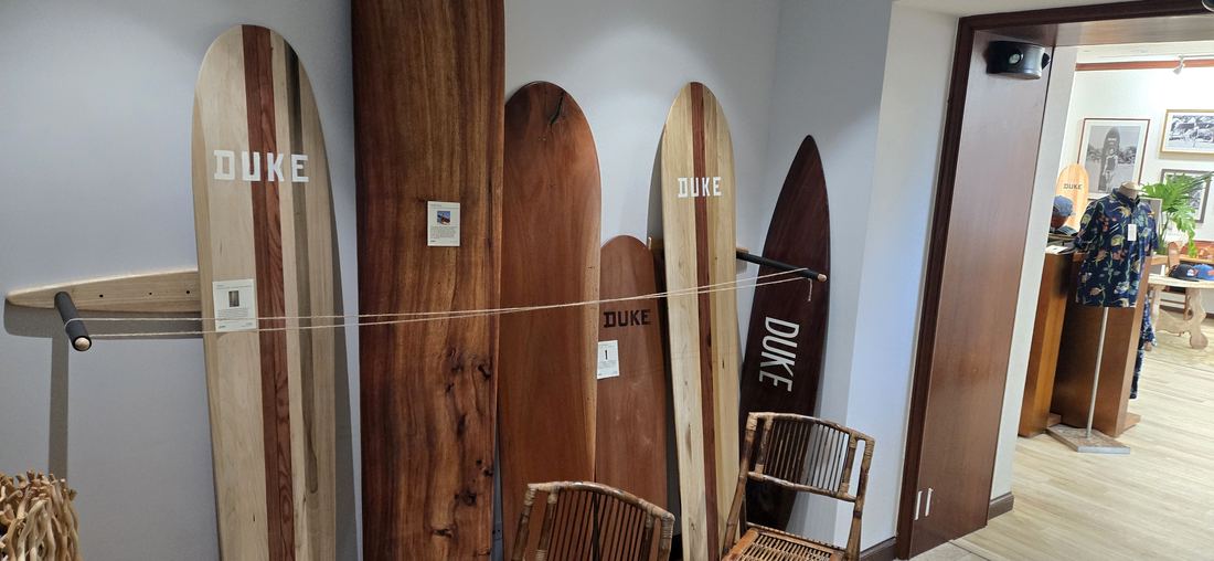 A row of wooden boards leaning against the wall, the nearest marked DUKE.